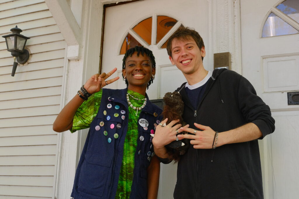 Aiden (playing Constance) & Nick (playing Worm Breath) hold Miller (puppet) on the porch.