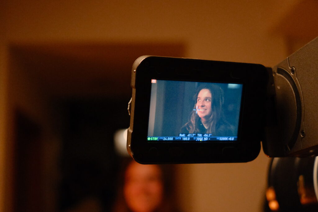Kayla (gaffer) on the camera monitor.
