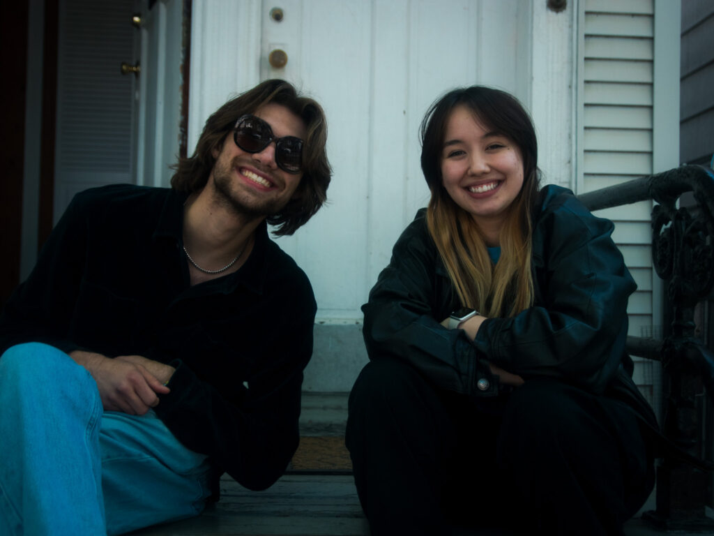 Josh (producer) and Erin (P.A.) smile at the camera on the front porch.