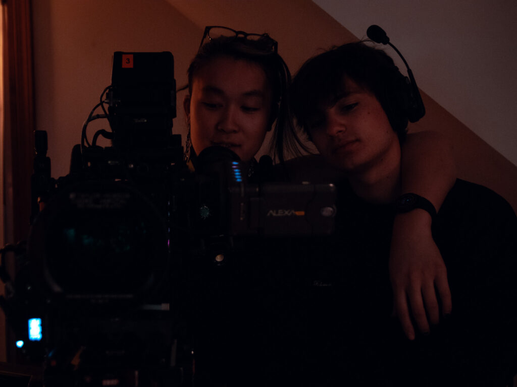 Cam team stands arm-in-arm in front of the ARRI Alexa Mini.