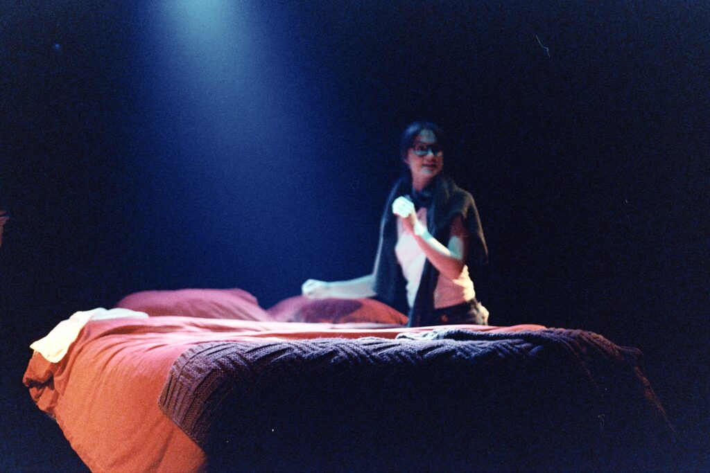 Katie (production designer) prepares the bed for shooting.