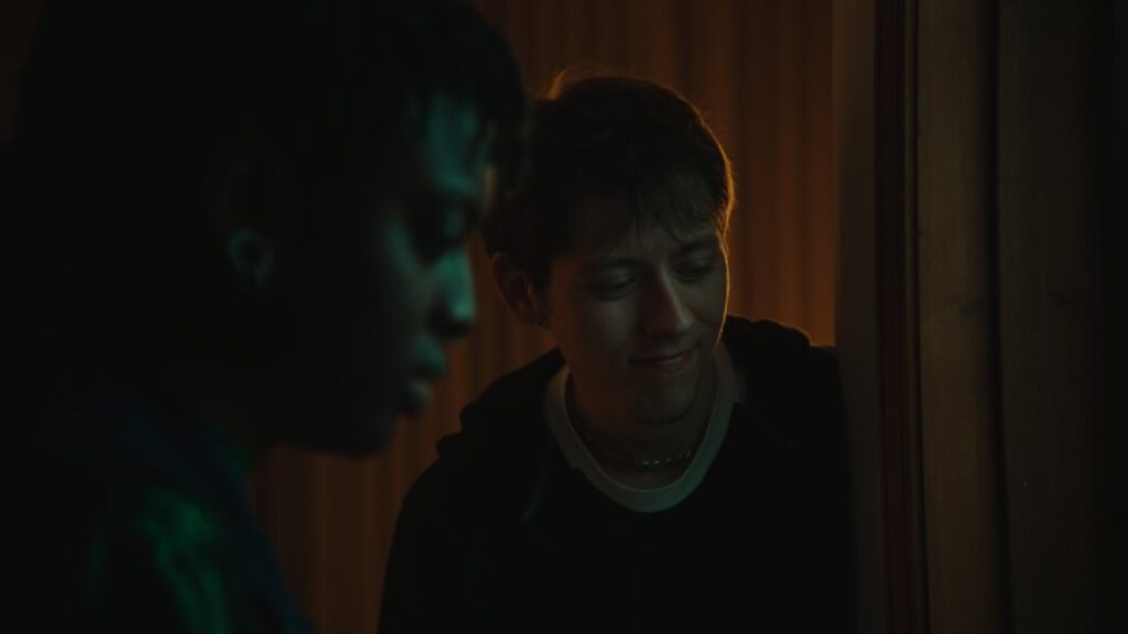 Worm Breath and Constance look downwards into a cold blue light.