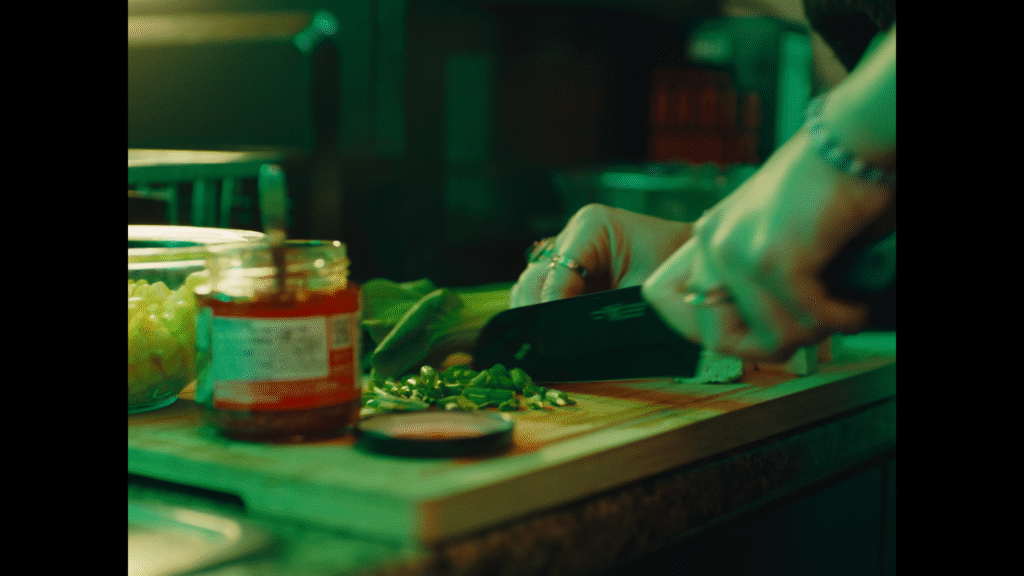 A close-up on Valerie's hands chopping green onions.
